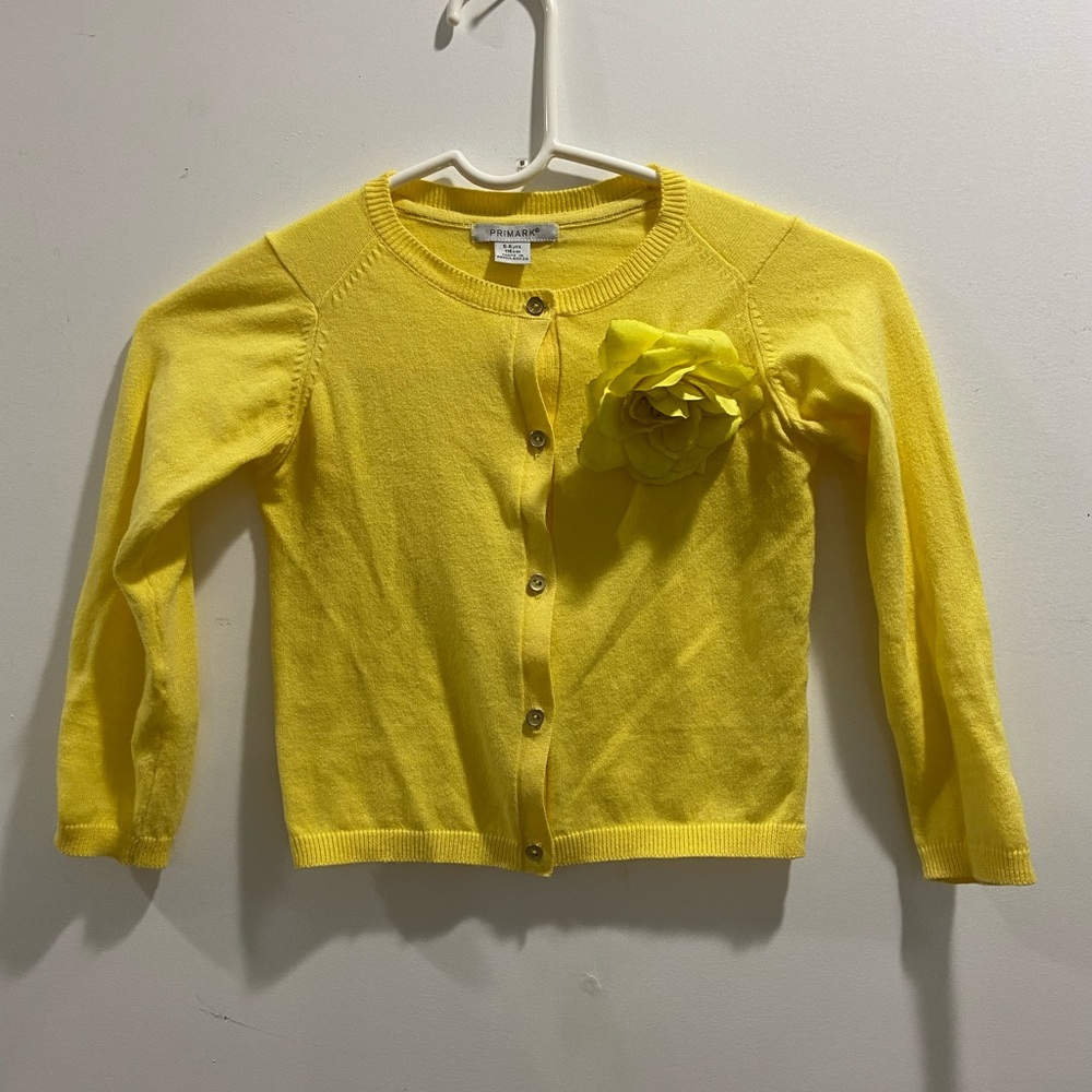 Yellow sweater can be worn over a dress